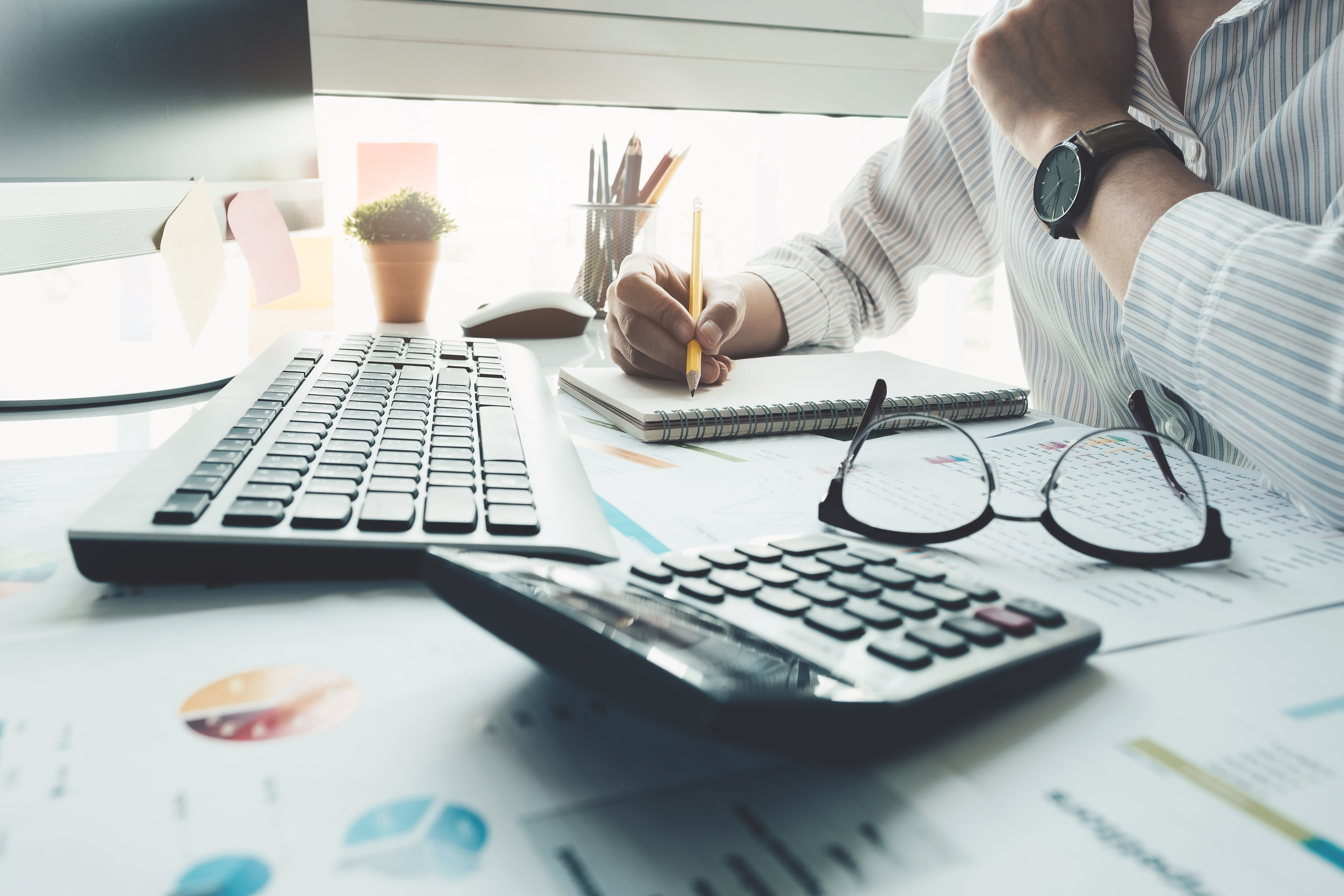 accountant working with calculator and graphs